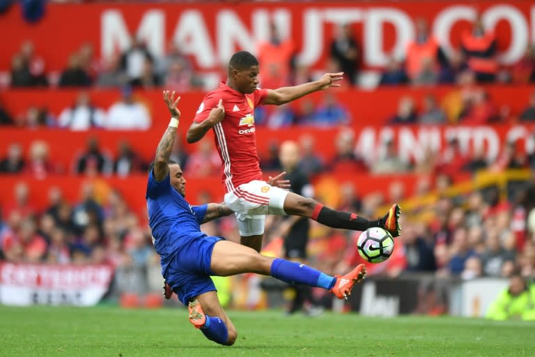 Manchester United striker Marcus Rashford (R) is tackled by Leicester City defender Danny Simpson during the English Premier League match at Old Trafford in Manchester, north-west England, on September 24, 2016