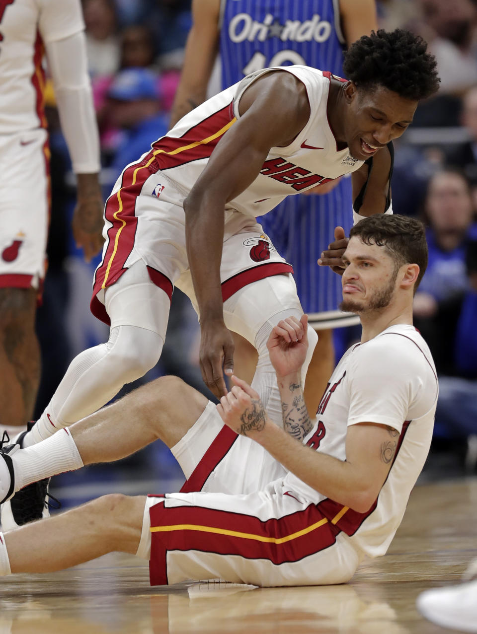 Miami Heat's Tyler Johnson, right, pumps his fists after making a three-point basket against the Orlando Magic and drawing a foul as teammate Josh Richardson comes in to help him up during the second half of an NBA basketball game, Sunday, Dec. 23, 2018, in Orlando, Fla. (AP Photo/John Raoux)