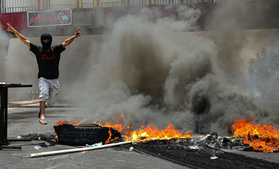 Protesters burn tires to block roads during a demonstration demanding the return of electricity in Basra, southeast of Baghdad, Iraq, Friday, July 2, 2021. A widespread power outage is hitting Iraq as temperatures reach scorching levels, affecting even affluent areas in the capital and stirring concerns of widespread unrest. (AP Photo/Nabil al-Jurani)