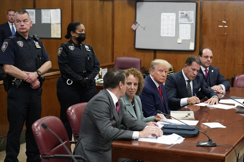 Former President Donald Trump sits at the defense table with his legal team in a Manhattan court, Tuesday, April 4, 2023, in New York. Trump is appearing in court on charges related to falsifying business records in a hush money investigation, the first president ever to be charged with a crime. (AP Photo/Seth Wenig, Pool)