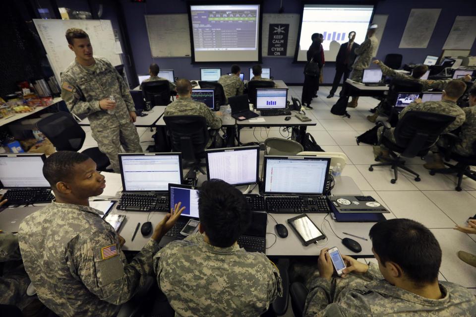 United States Military Academy cadets watch data on computers at the Cyber Research Center at the United States Military Academy in West Point, N.Y., Wednesday, April 9, 2014. The West Point cadets are fending off cyber attacks this week as part of an exercise involving all the service academies. The annual Cyber Defense Exercise requires teams from the five service academies to create computer networks that can withstand attacks from the National Security Agency and the Department of Defense. (AP Photo/Mel Evans)