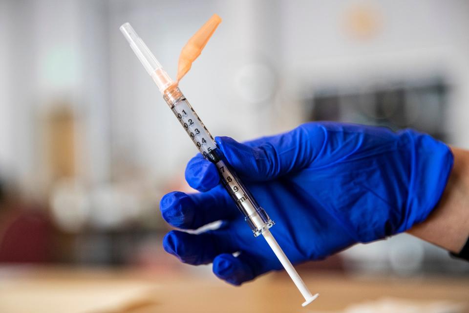 A nurse holds a dose of the Moderna COVID-19 vaccine during a vaccination clinic at the Mizell Center in Palm Springs, Calif., on February 27, 2021.