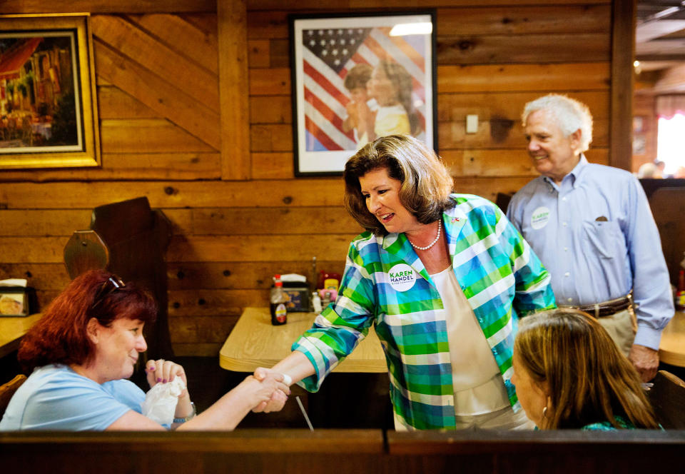 <p>Karen Handel, Republican candidate for Georgia’s 6th congressional district, center, greets diners during a campaign stop at Old Hickory House in Tucker, Ga., Monday, June 19, 2017. (Photo: David Goldman/AP) </p>