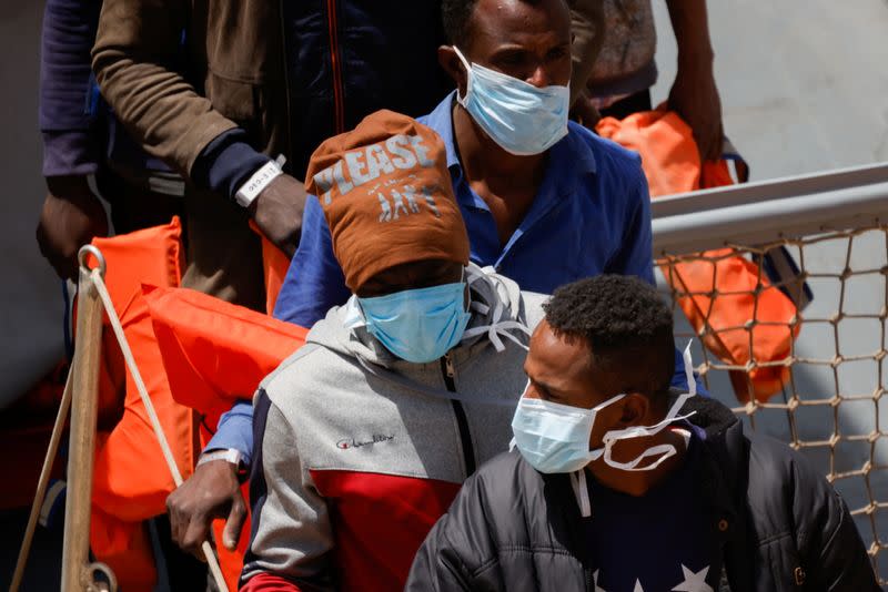 Rescued migrants disembark from an Armed Forces of Malta vessel in Senglea, in Valletta's Grand Harbour