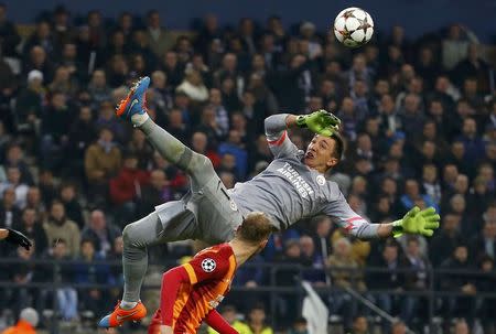 Goalkeeper Fernando Muslera of Galatasaray (top) jumps for a ball during their Champions League soccer match against Anderlecht at Constant Vanden Stock stadium in Brussels November 26, 2014. REUTERS/Yves Herman