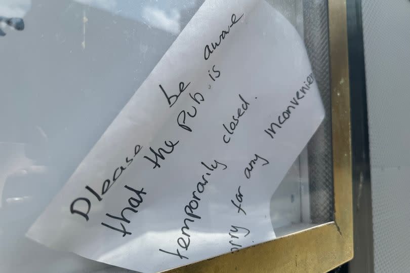 A notice outside McGlynn's pub says: "Please be aware that the pub is temporarily closed. Sorry for any inconvenience."