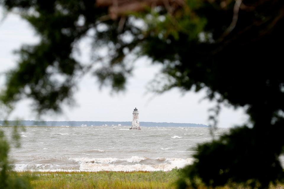 White caps, stirred by heavy winds and high seas, roll through Lazaretto Creek around the Cockspur Lighthouse on Wednesday.