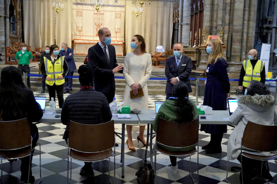 Britain's Prince William, Duke of Cambridge and Britain's Catherine, Duchess of Cambridge speak to staff during a visit to the coronavirus vaccination centre at Westminster Abbey, central London on March 23, 2021, to pay tribute to the efforts of those involved in the Covid-19 vaccine rollout. (Photo by Aaron Chown / POOL / AFP) (Photo by AARON CHOWN/POOL/AFP via Getty Images)