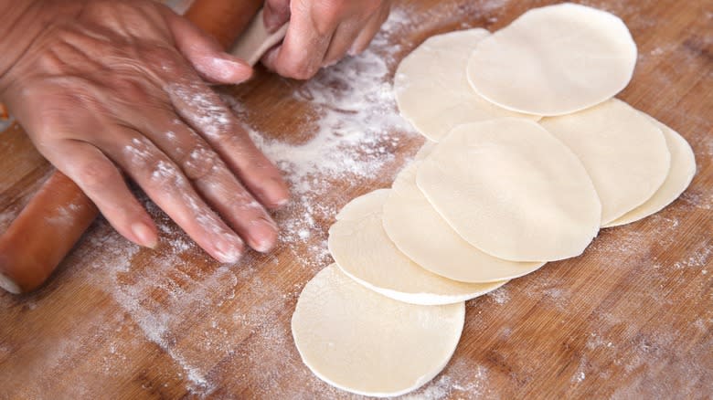 Person rolling Jiaozi wrappers