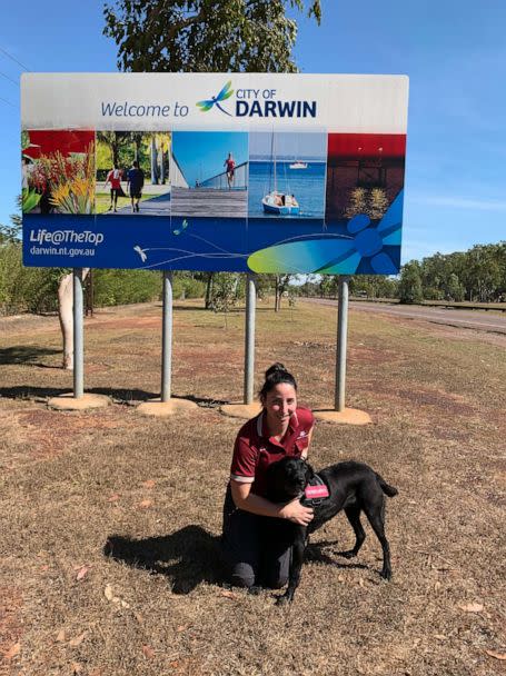 PHOTO: Detector Dog Zinta is shown with her handler in Darwin, Australia. (Australian Government Department of Agriculture, Fisheries and Forestry)