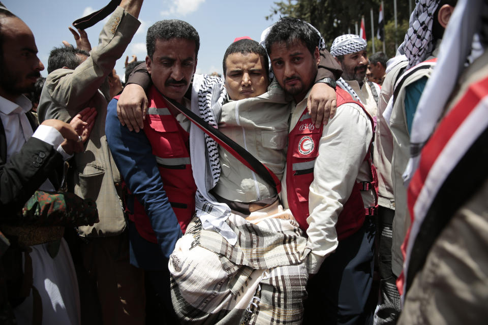 Paramedics carry a Houthi prisoner as he arrived to Sanaa airport, Friday, April 14, 2023. An exchange of more than 800 prisoners linked to Yemen's long-running war them began Friday, the International Committee for the Red Cross said. The three-day operations will see flights transport prisoners between Saudi Arabia and Yemen's capital, Sanaa, long held by the Iranian-backed Houthi rebels. ((AP Photo/Hani Mohammed)