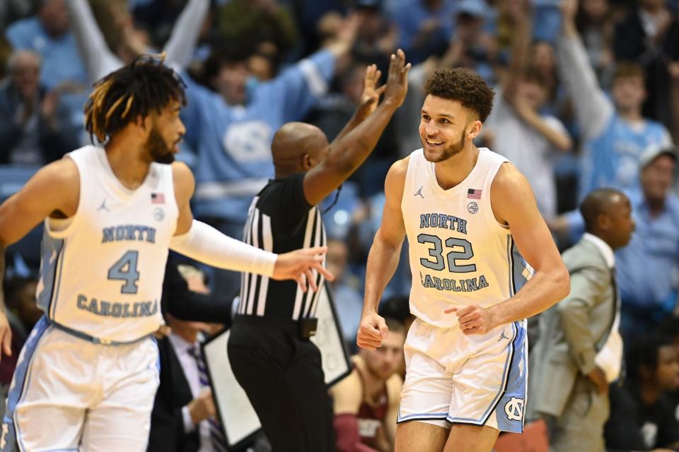 Jan 17, 2023; Chapel Hill, North Carolina, USA; North Carolina Tar Heels forward Pete Nance (32) reacts with guard R.J. Davis (4) after hitting a three point shot in the first half at Dean E. Smith Center. Mandatory Credit: Bob Donnan-USA TODAY Sports