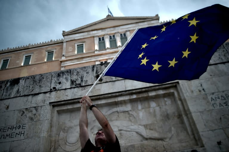 A pro-European Union protester waves an EU flag during a demonstration in front of the parliament in Athens on June 30, 2015. 2015