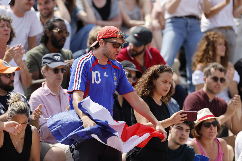 A fan encourages France's Hugo Gaston during the first round match of the French Open tennis tournament against Slovakia's Alex Molcan at the Roland Garros stadium in Paris, Tuesday, May 30, 2023. (AP Photo/Jean-Francois Badias)