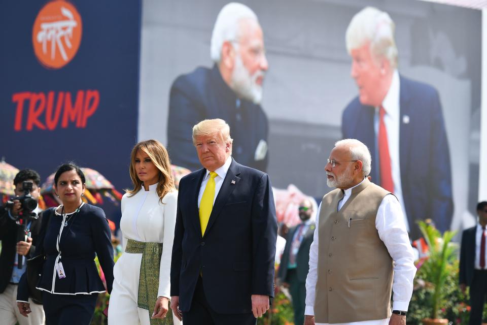 India's Prime Minister Narendra Modi (R) greets US President Donald Trump (C) and First Lady Melania Trump (2L) upon their arrival at Sardar Vallabhbhai Patel International Airport in Ahmedabad on February 24, 2020. (Photo by Mandel NGAN / AFP) (Photo by MANDEL NGAN/AFP via Getty Images)