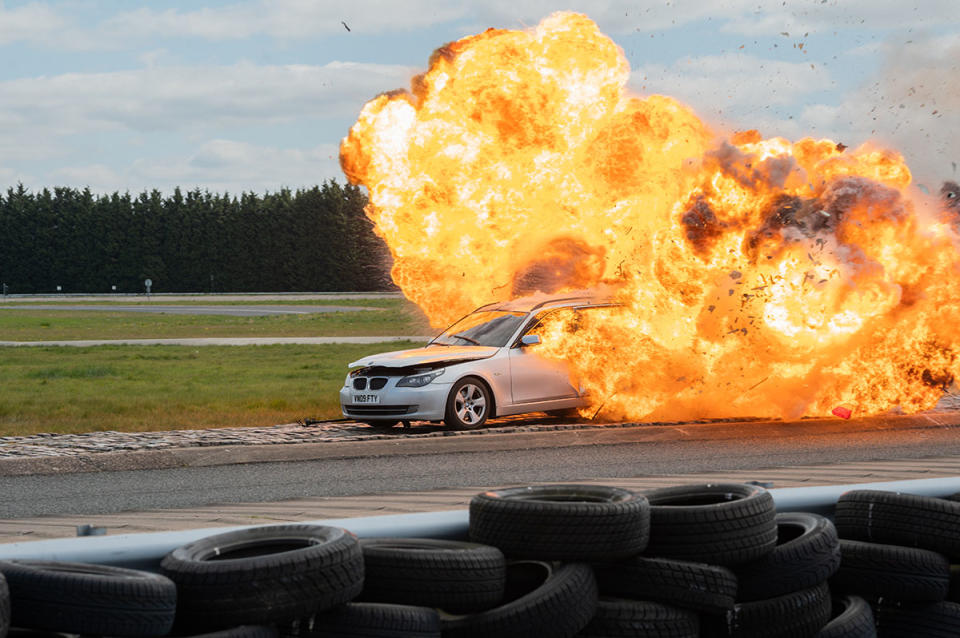 A silver BMW explodes into a fireball on a race track in The Grand Tour Presents: Carnage A Trois. Photo: Amazon Prime Video (supplied).