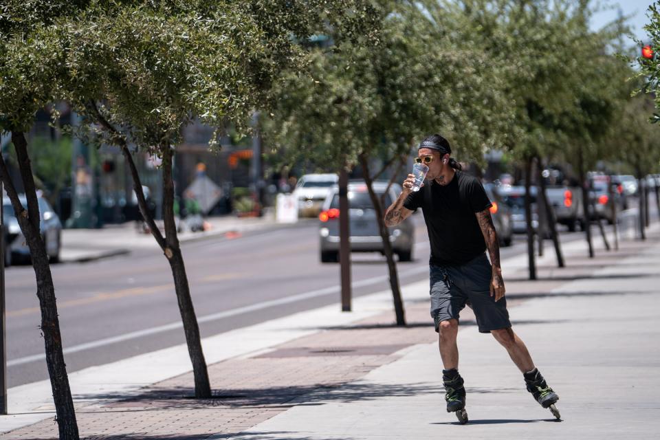 A person rollerblades along Roosevelt Row in Phoenix on July 5, 2023. An Excessive Heat Warning issued by the National Weather Service is in effect until July 7 at 8 p.m.