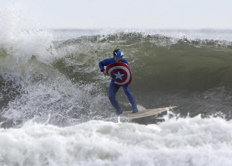 A participant surfs during the third annual Rockaway Halloween surf competition at Rockaway Beach in the Queens borough of New York