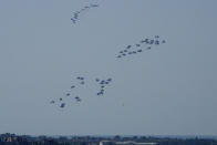 Parachutes drop humanitarian aid into the northern Gaza Strip, as seen from southern Israel, Monday, March 11, 2024. (AP Photo/Maya Alleruzzo)