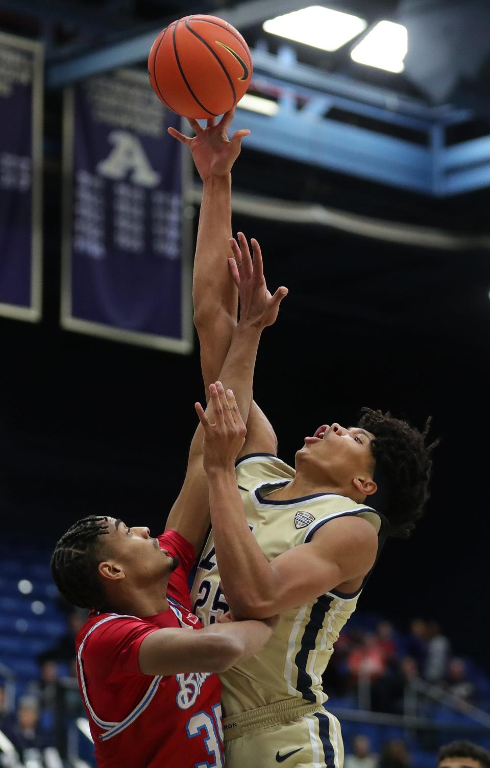 Akron Zips forward Enrique Freeman (25) takes a shot over Bradley Braves forward Darius Hannah (35) during the first half of an NCAA college basketball game, Tuesday, Dec. 5, 2023, in Akron, Ohio.