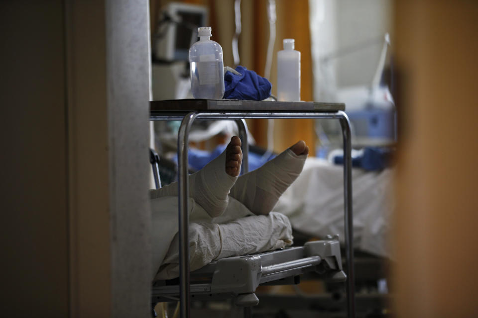 A COVID-19 patient with his feet wrapped in bandages lies on a bed of the Mexico City Ajusco Medio General Hospital ICU ward, Wednesday, Dec. 2. 2020. Mexico continues to reported an increase in the number of coronavirus cases, with Mexico City continuing to report the biggest portion of the surge. (AP Photo/Marco Ugarte)