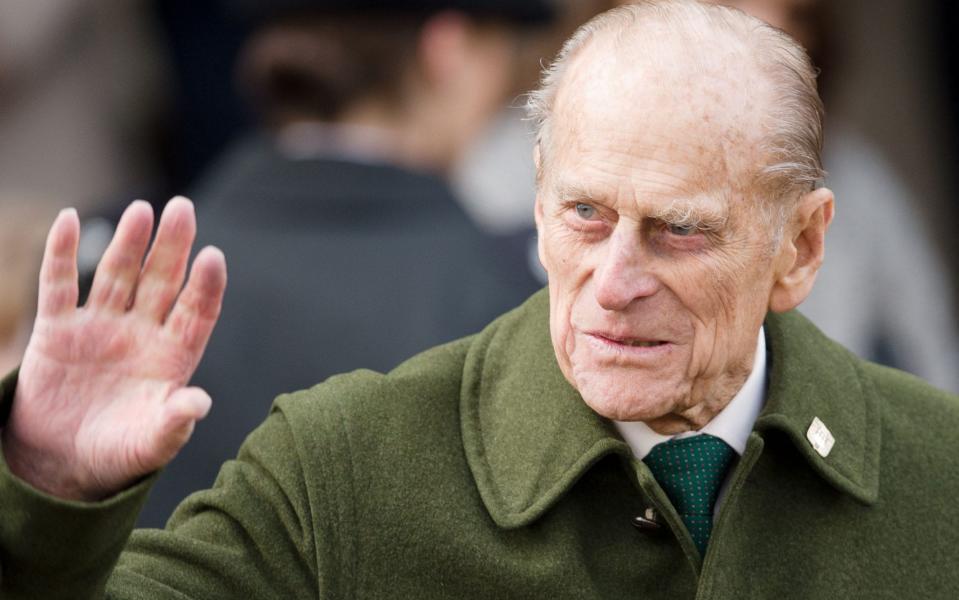 Prince Philip waves to well-wishers as he leaves following the Royal family Christmas Day church service at St Mary Magdalene Church in Sandringham on December 25, 2012 - Leon Neal/AFP