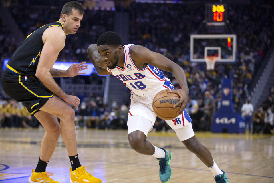 Philadelphia 76ers forward Shake Milton (18) drives past Golden State Warriors forward Nemanja Bjelica during the first quarter of an NBA basketball game Wednesday, Nov. 24, 2021, in San Francisco. (AP Photo/D. Ross Cameron)