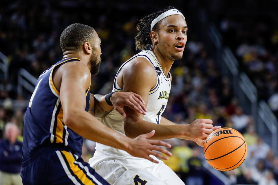 Michigan forward Terrance Williams II (5) dribbles against Toledo forward Setric Millner Jr. (4) during the second half of the first round of the NIT at Crisler Center in Ann Arbor on Tuesday, March 14, 2023.