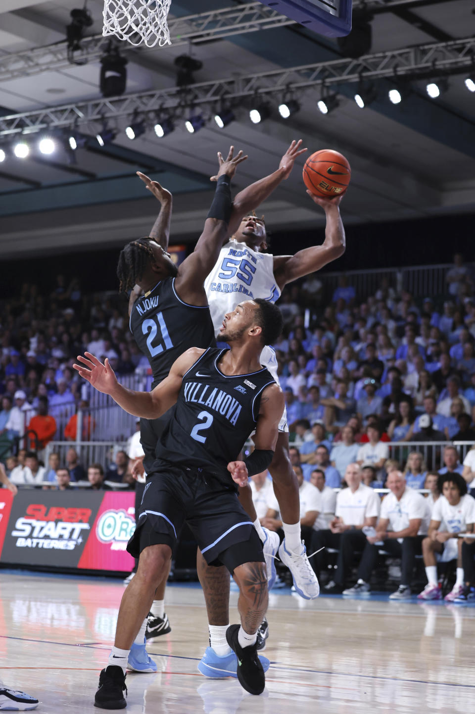 In a photo provided by Bahamas Visual Services, North Carolina's Harrison Ingram trying to get over Villanova's Nnanna Njoku during an an NCAA college basketball game in the Battle 4 Atlantis at Paradise Island, Bahamas, Thursday, Nov. 23, 2023. (Tim Aylen/Bahamas Visual Services via AP)