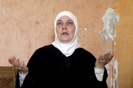 Fawziyeh, a 52-year-old Syrian woman, gestures while speaking during an interview with Reuters at her house in a small town south of Beirut, Lebanon April 15, 2015. REUTERS/Aziz Taher