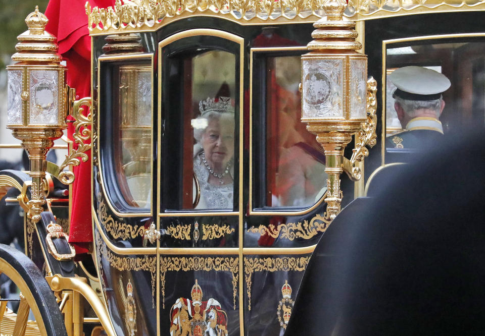 Britain's Queen Elizabeth II travels in a carriage to parliament for the official State Opening of Parliament in London, Monday, Oct. 14, 2019. (AP Photo/Frank Augstein)