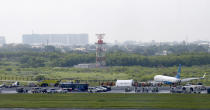 A Boeing passenger plane from China, a Xiamen Air, sits on the grassy portion of the runway of the Ninoy Aquino International Airport after it skidded off the runway while landing Friday, Aug. 17, 2018 in suburban Pasay city southeast of Manila, Philippines. All the passengers and crew of Xiamen Air Flight 8667 were safe and were taken to an airport terminal, where they were given blankets and food before being taken to a hotel. The left engine is visible on the left. (AP Photo/Bullit Marquez)