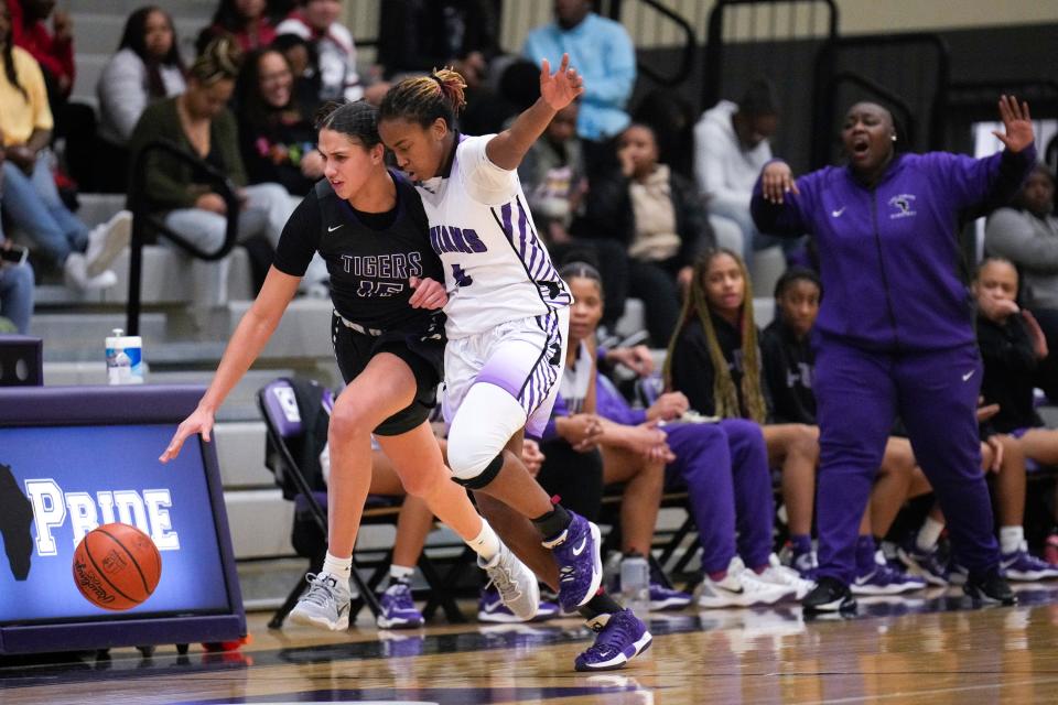 Pickerington Central's Olivia Cooper, left, and Africentric's Samairah Thompson battle for the ball during their game Saturday at Africentric. Central won 58-48.