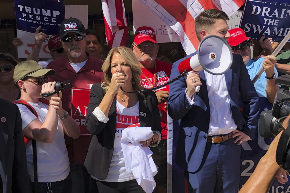 Arizona Republican Party Chairman Kelli Ward speaks to a crowd outside a field office for a Democratic congressman in Casa Grande, Ariz., Oct. 8, 2019. (AP Photo/Jonathan J. Cooper)