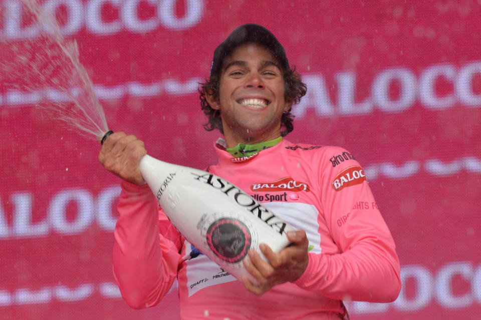 Australia's Michael Matthews sprays sparkling wine as he celebrates on the podium after clinching the overall leader's pink jersey at the end of the 218-kilometer (135-mile) second stage of the Giro d'Italia, Tour of Italy cycling race, from Belfast to Belfast, Northern Ireland, Saturday May 10, 2014. (AP Photo/Giuan Mattia D'Alberto)