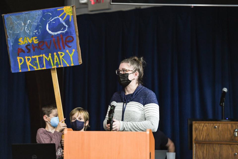 Asheville Primary School parent Melinda Hopkins spoke at the Asheville City School board meeting regarding the Asheville Primary School on December 7, 2021. Asheville Primary students Carrick, 8, and McCullough, stood with her.
