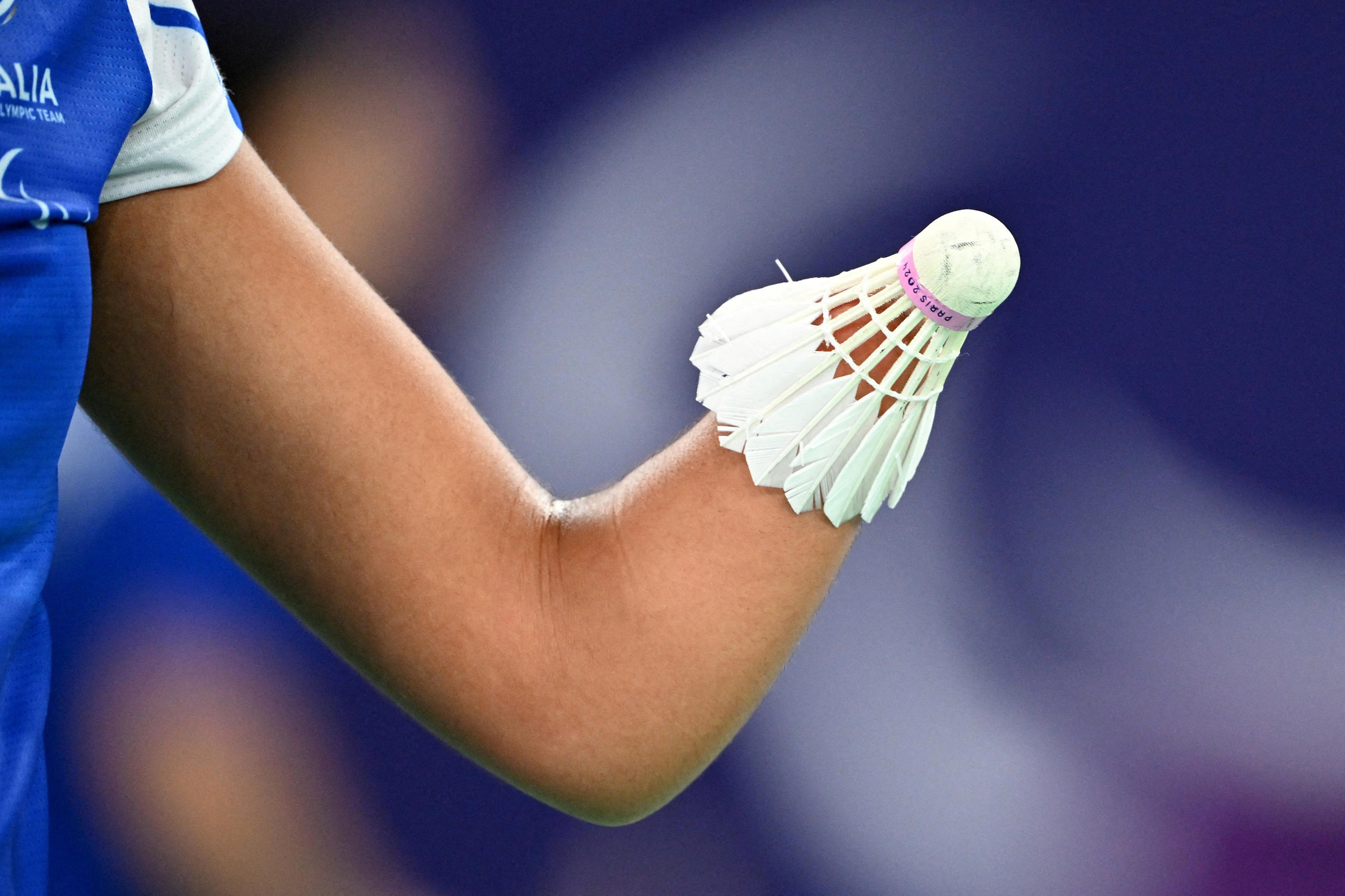 A participant holds a badminton shuttlecock.