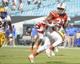 Miami running back Cam'Ron Harris (23) runs for a first quarter touchdown after a reception against Pittsburgh during an NCAA college football game at Hard Rock Stadium in Miami Gardens, Fla., Saturday, Oct. 17, 2020. (Al Diaz/Miami Herald via AP)