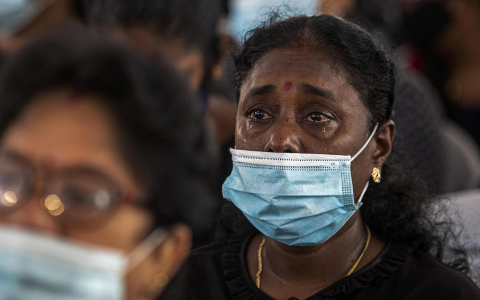 A Sri Lankan woman weeps during a memorial service for the victims of 2019 Easter Sunday attacks at St. Anthony's Church in Colombo, Sri Lanka, Wednesday, April 21, 2021. Wednesday marked the second anniversary of the serial blasts that killed 269 people. (AP Photo/Eranga Jayawardena)