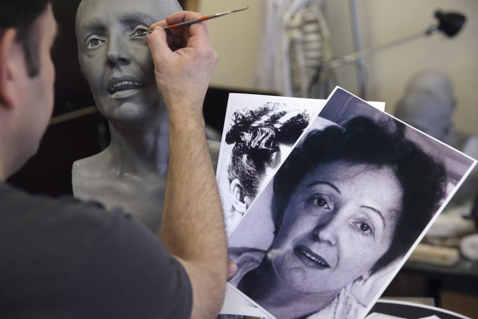 Paris' Grevin Wax Museum sculptor Stephane Barret works on the head of late French singer Edith Piaf in the museum workshop in Paris