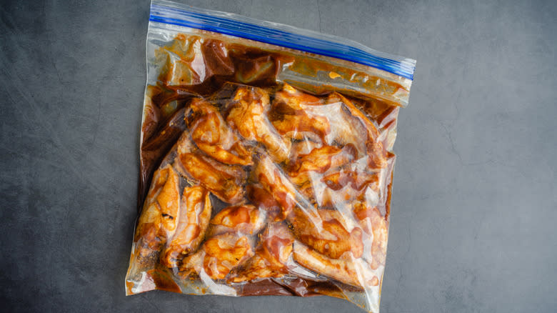 A bag of chicken wings in a marinade
