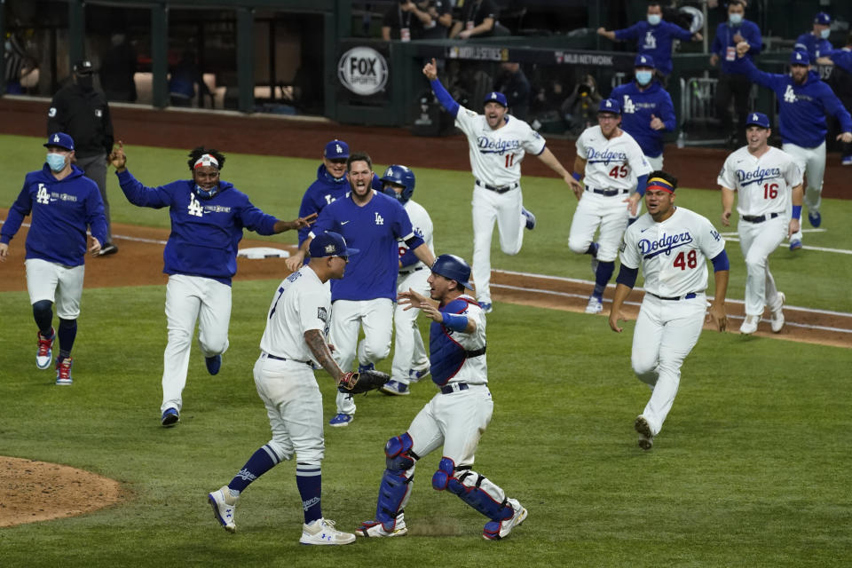 FILE - In this Oct. 27, 2020, file photo, Los Angeles Dodgers celebrate after defeating the Tampa Bay Rays 3-1 in in Game 6 to win baseball's World Series in Arlington, Texas. (AP Photo/Tony Gutierrez, File)