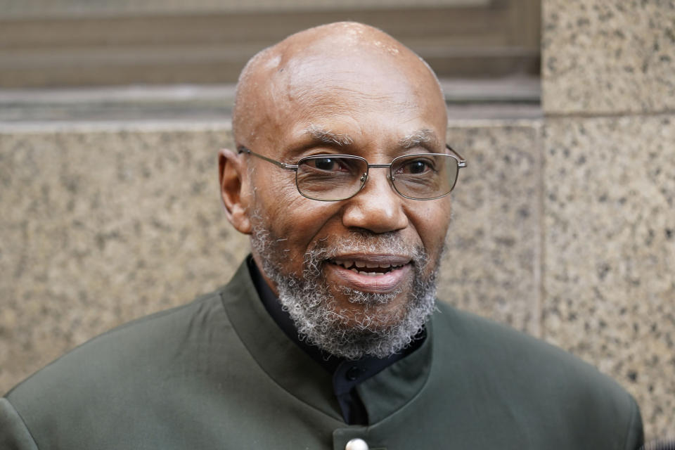 FILE - Muhammad Aziz stands outside the courthouse with members of his family after his conviction in the killing of Malcolm X was vacated on Nov. 18, 2021, in New York. Aziz, 84, has filed a $40 million lawsuit against New York City for the two decades he spent in prison for a notorious crime he did not commit. (AP Photo/Seth Wenig, File)