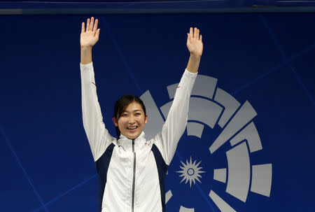 FILE PHOTO: Swimming - 2018 Asian Games - Women's 50m Freestyle - GBK Aquatic Center, Jakarta, Indonesia - August 24, 2018 Japan's Rikako Ikee celebrates on the podium after winning the Women's 50m Freestyle REUTERS/Jeremy Lee