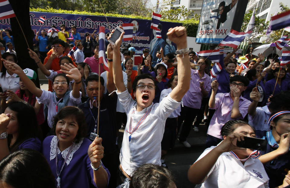 A supporter cheers on a passing anti-government march in Bangkok Thursday, Jan. 30, 2014. Thailand's government announced Tuesday it will go ahead with an election this weekend despite an opposition boycott, months of street protests and the likelihood of more violence in the country's political crisis. (AP Photo/Wally Santana)