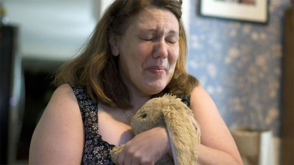 Dorothy McIntosh Shuemake cries as she clutches her daughter's toy stuffed rabbit during an interview at her home in, Ohio. Photo: AP/John Minchillo