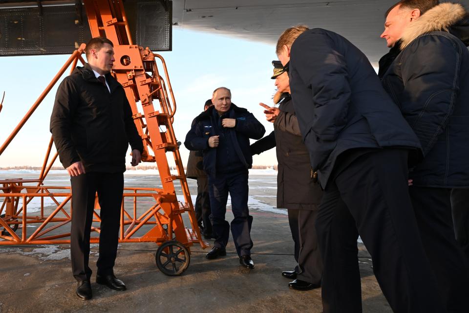 Russian President Vladimir Putin, center, gets off a Tu-160M strategic bomber after a flight in Kazan, Russia, Thursday, Feb. 22, 2024. (Dmitry Azarov, Sputnik, Kremlin Pool Photo via AP)