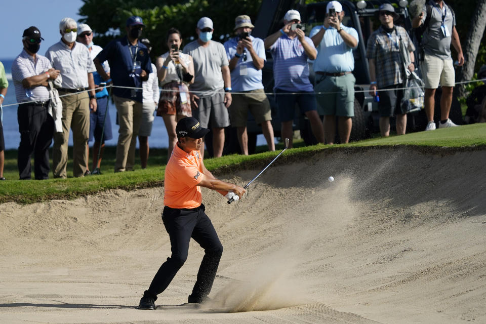 Kevin Na hits out of the 11th bunker during the first round of the Sony Open golf tournament, Thursday, Jan. 13, 2022, at Waialae Country Club in Honolulu. (AP Photo/Matt York)