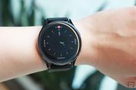 <p>OnePlus Watch review photos. OnePlus Watch on a wrist showing a faux analog watch face with markers for progress on Calories, Steps and Workout.</p> 