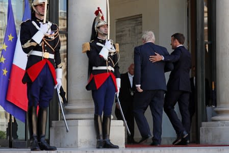 French President Emmanuel Macron welcomes British Prime Minister Boris Johnson before a meeting on Brexit at the Elysee Palace in Paris